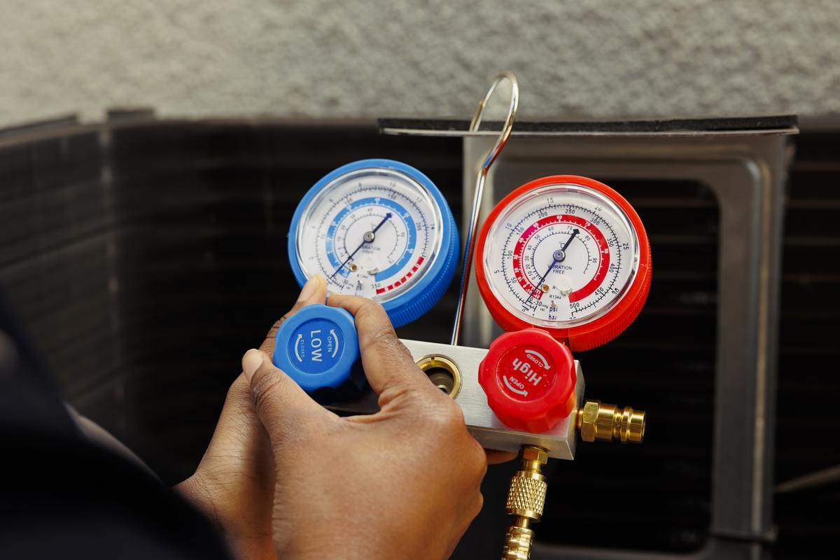 Refrigerant manifold gauges connected to an air conditioner